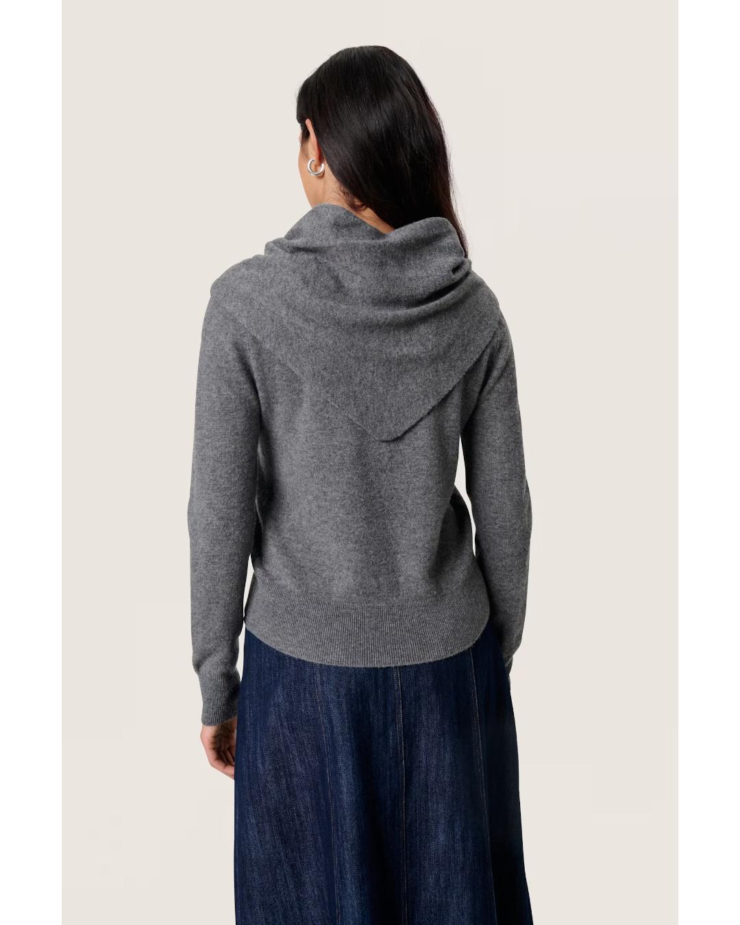 grey cardigan with a scarf attached over the shoulders 