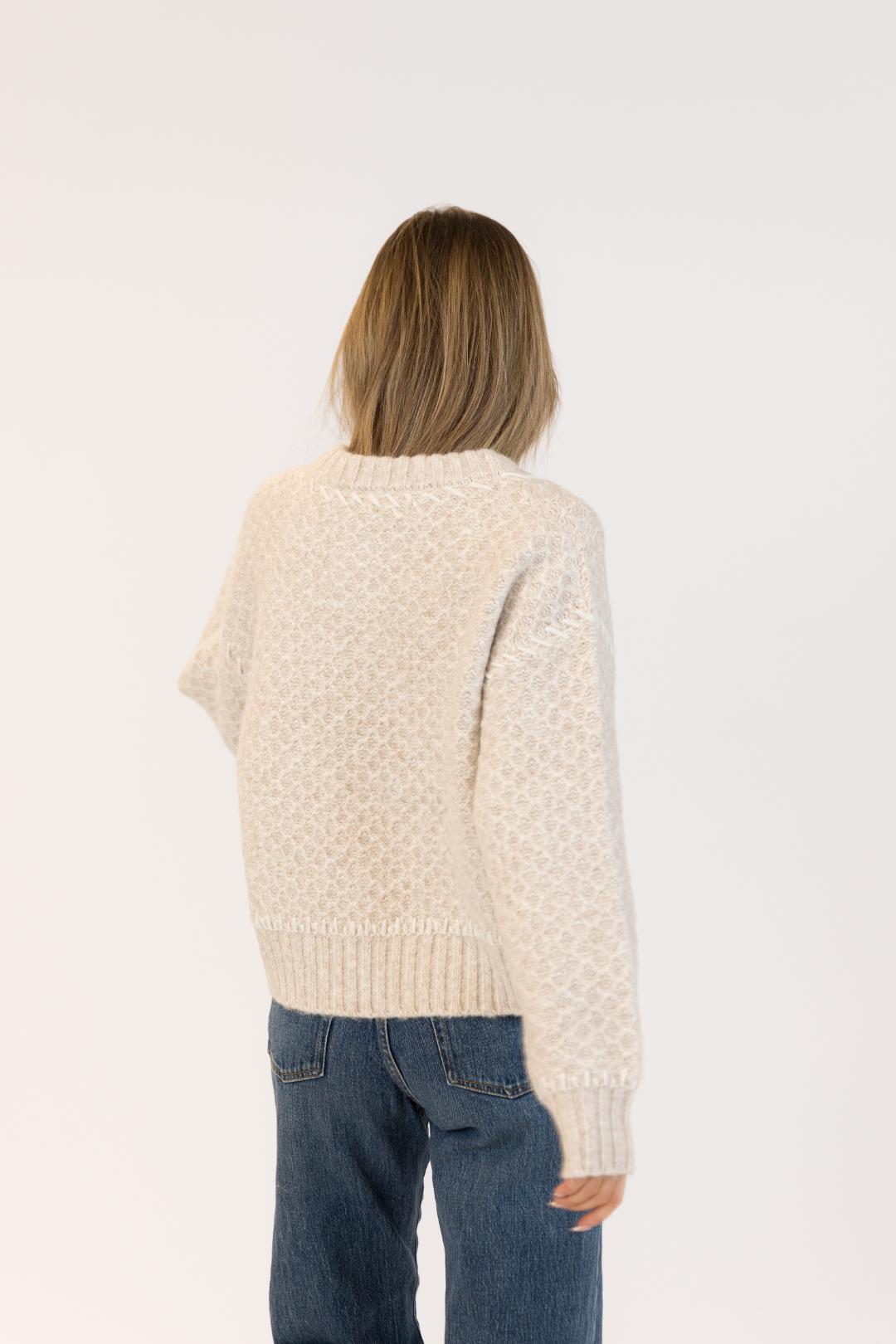 back view of a beige knit sweater