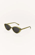 Sunglasses with gold frame and dark lenses on a white background