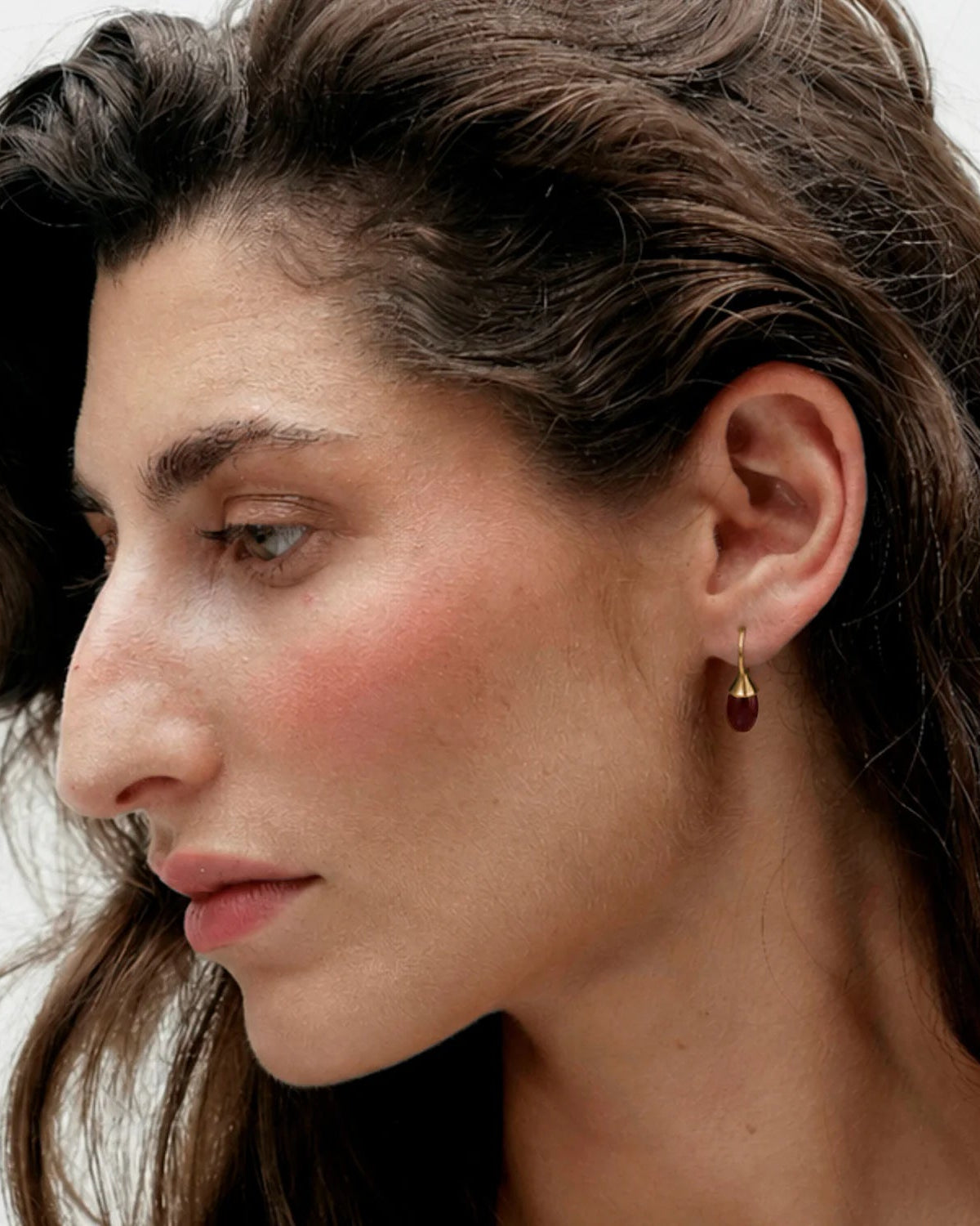 gold drop earring with accent red stone