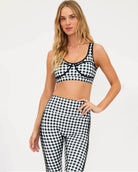 Woman wearing a black and white checkered bra top and matching leggings
