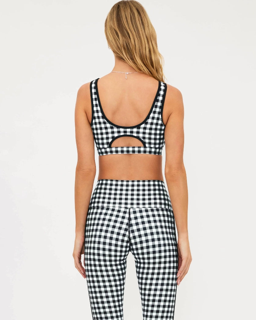 Woman wearing a black and white checkered bra top and matching leggings