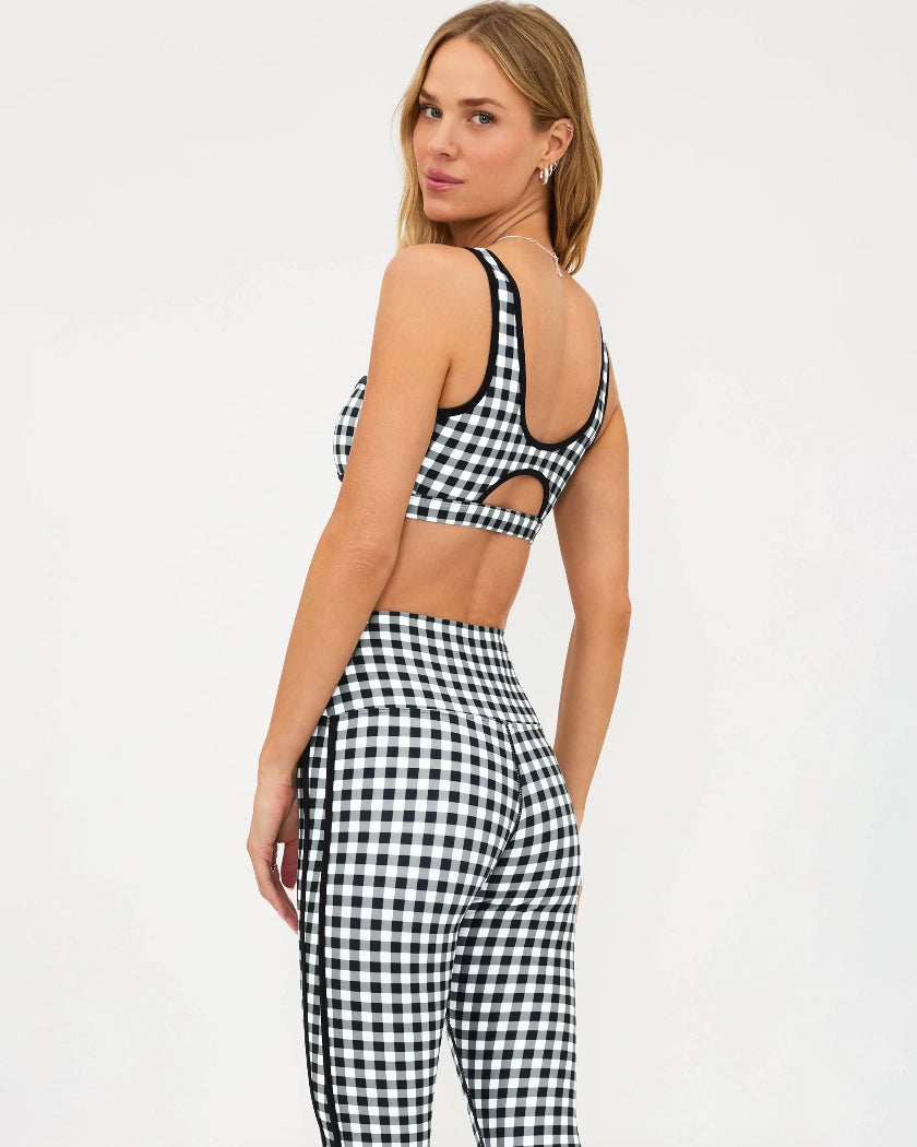 Woman wearing a black and white checkered bra top and matching leggings