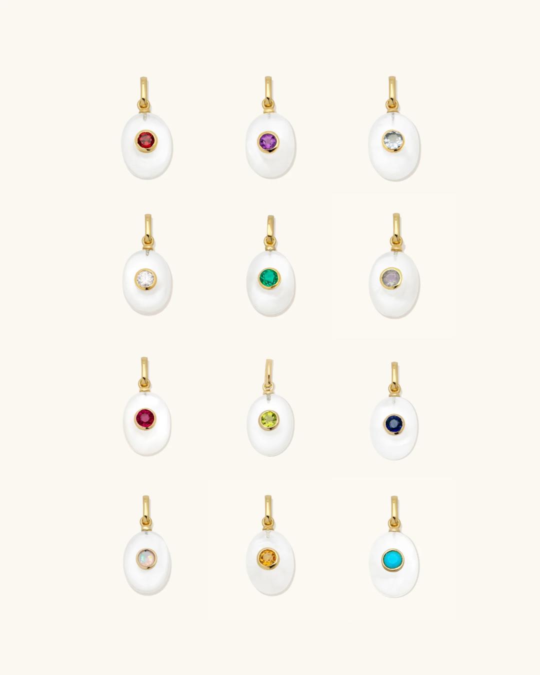 pearl charm with a birthstone in the middle