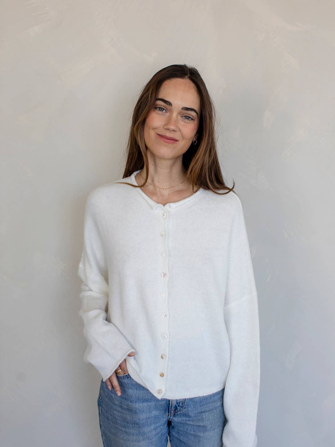 white cardigan that has buttons up the front