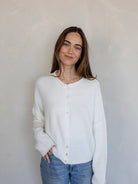white cardigan that has buttons up the front