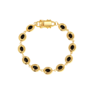 gold oval charm bracelet with black stone in the middle 