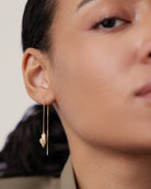 gold threader earrings with heart on bottom
