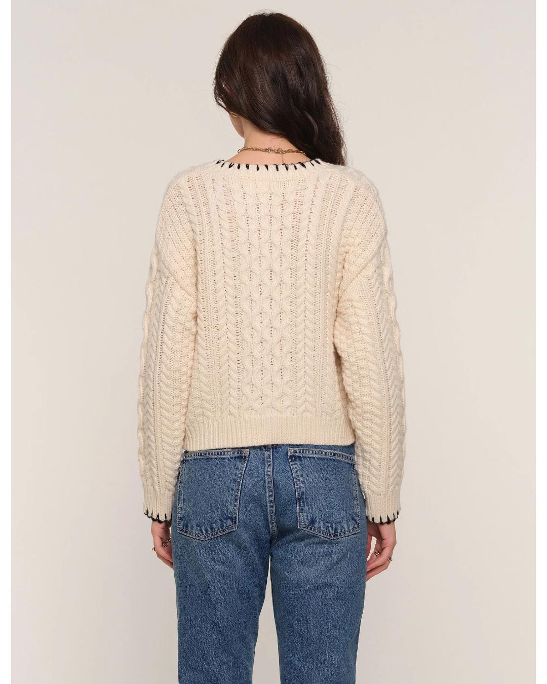 cream cardigan with black stitching outline