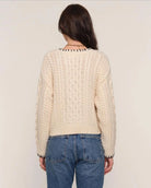 cream cardigan with black stitching outline