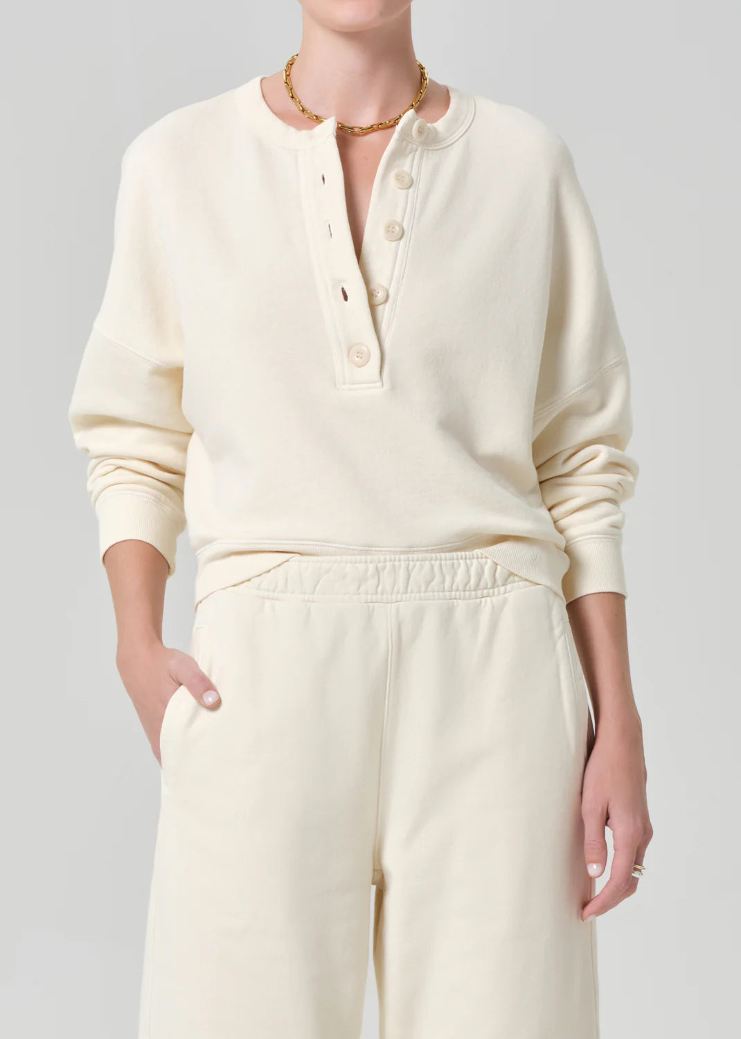 cream pullover sweater with buttons half way down