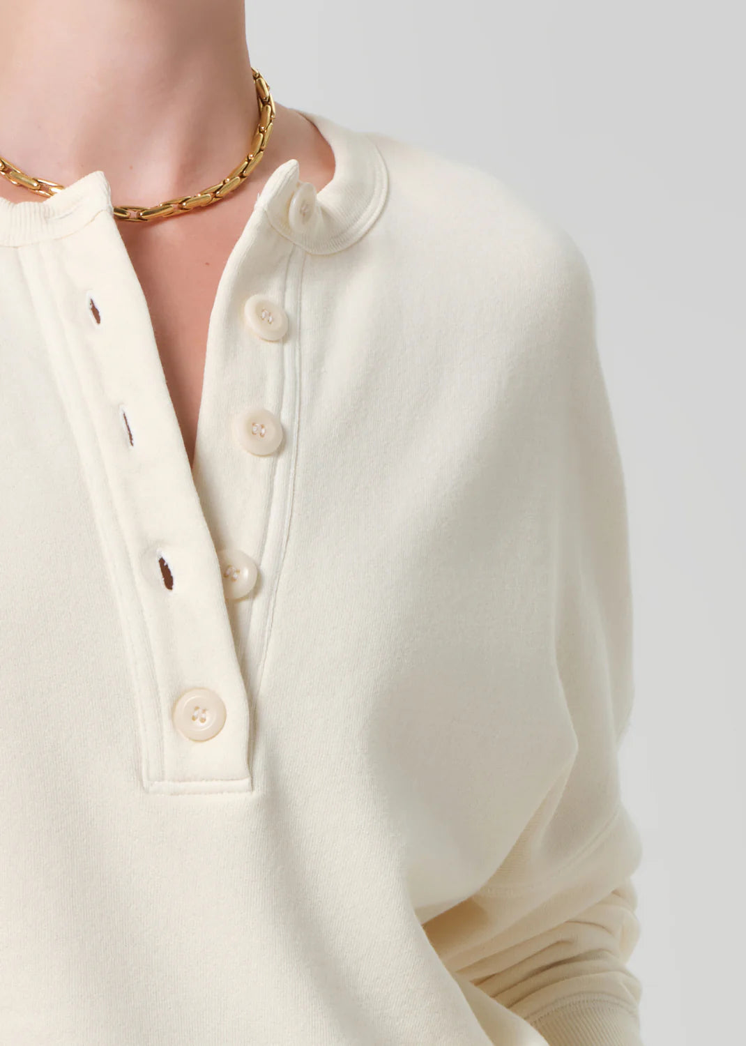 cream pullover sweater with buttons half way down