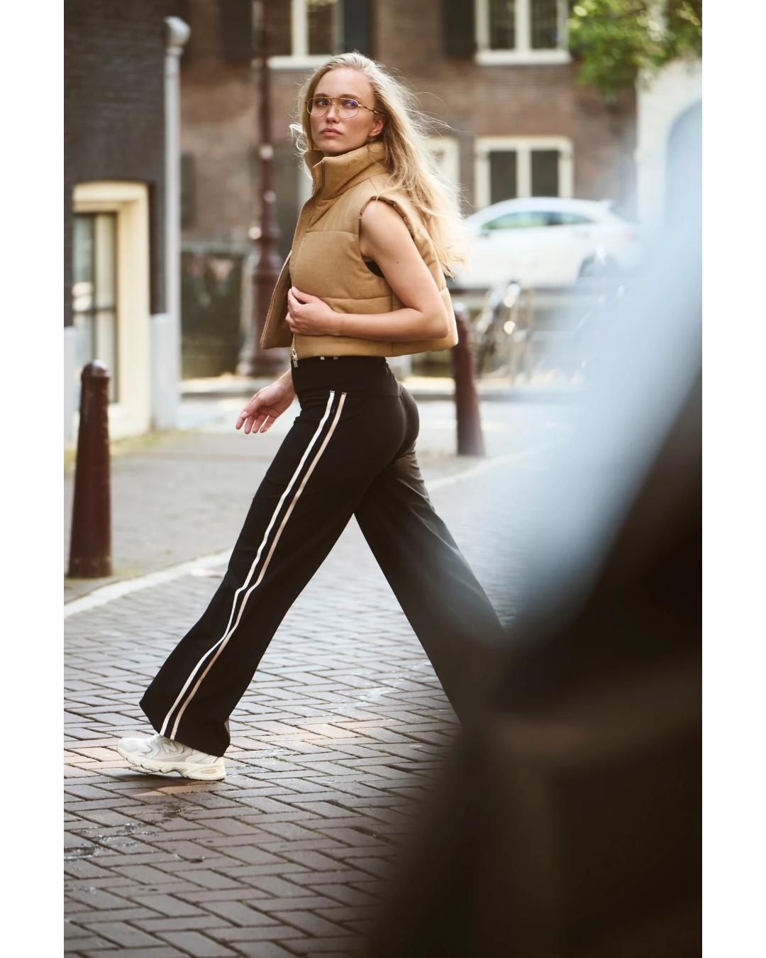 wide leg lack active track pant in black with two stripes down the sides