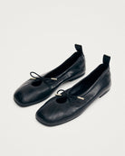 black leather ballet flats with a cut out and bow