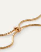 necklace with a statement gold pendant on a long thick gold chain