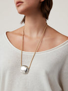 necklace with a statement silver pendant on a tan rope string