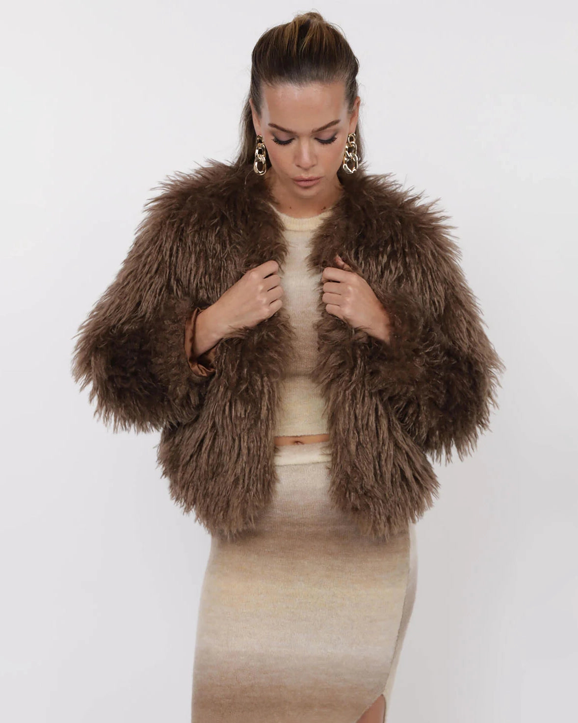 Woman wearing a brown fluffy faux fur jacket