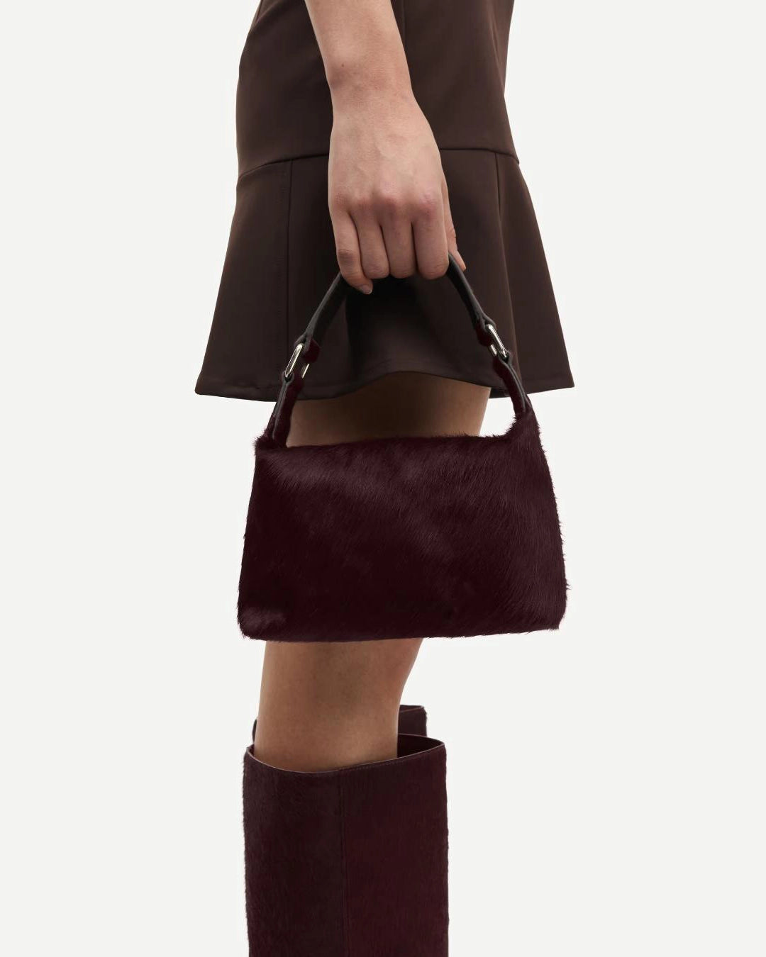 small purse with cow hair and leather in a burgundy