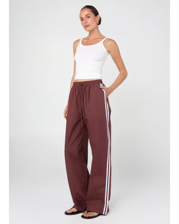 sporty pant in burgundy with cream stripe down the side