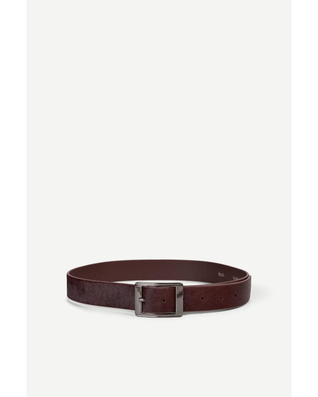 brown leather belt with cow hair and with a silver buckle