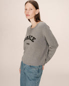 grey crewneck with grace paris written on the chest