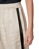 satin wide leg pant in beige with a black stripe down the side