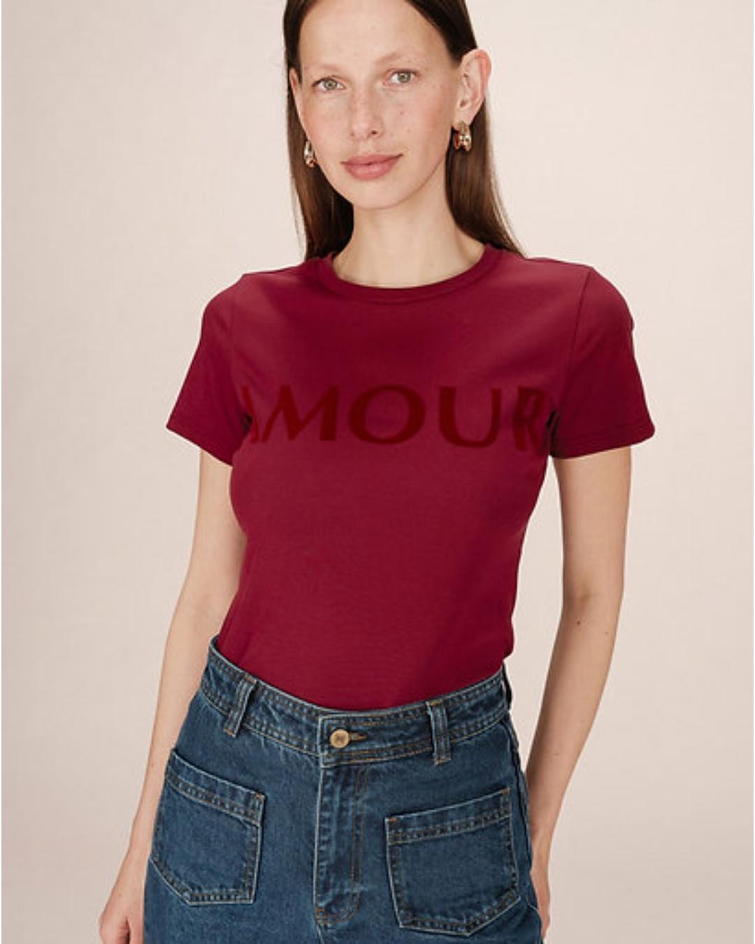 red t-shirt with amour written across the chest