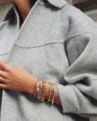 silver bangle with a square woven pendant