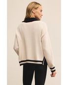 polo sweater with a half zip in cream and black on collar