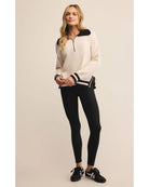 polo sweater with a half zip in cream and black on collar