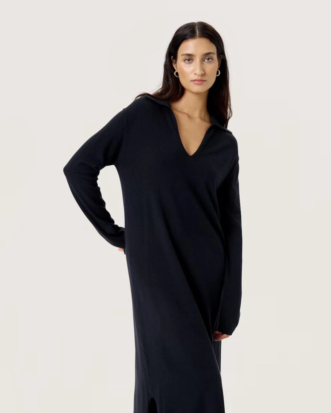 Woman wearing a black knit v neck dress