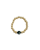beaded gold ring with green stone in the middle 