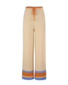 knit wide leg cream pants with orange and blue stripe on bottom