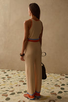 knit wide leg cream pants with orange and blue stripe on bottom
