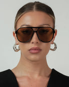 black aviator sunglasses with green lenses
