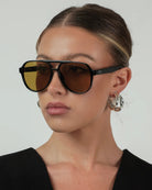 black aviator sunglasses with green lenses
