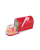 sugarfina 'love mail' candy box with pink brush and gummy candies on a white background