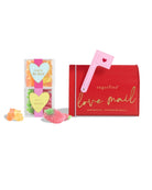 sugarfina 'love mail' candy box with pink brush and gummy candies on a white background