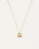gold necklace with a square gold pendant