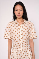 cream blouse with brown polka dots