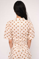 cream blouse with brown polka dots
