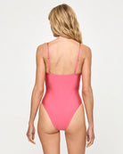 pink one piece swimsuit with gold hardware in the center