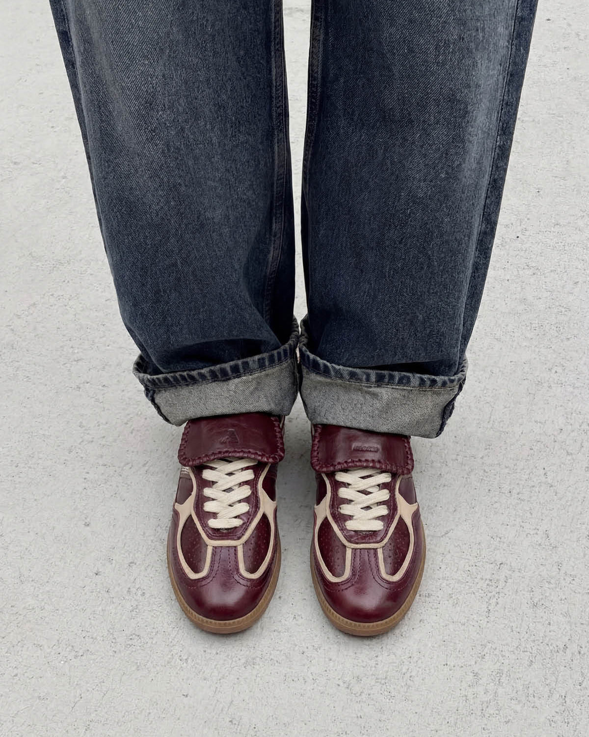 burgundy leather fashion sneaker with a fold over tongue 