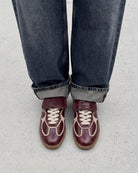 burgundy leather fashion sneaker with a fold over tongue 