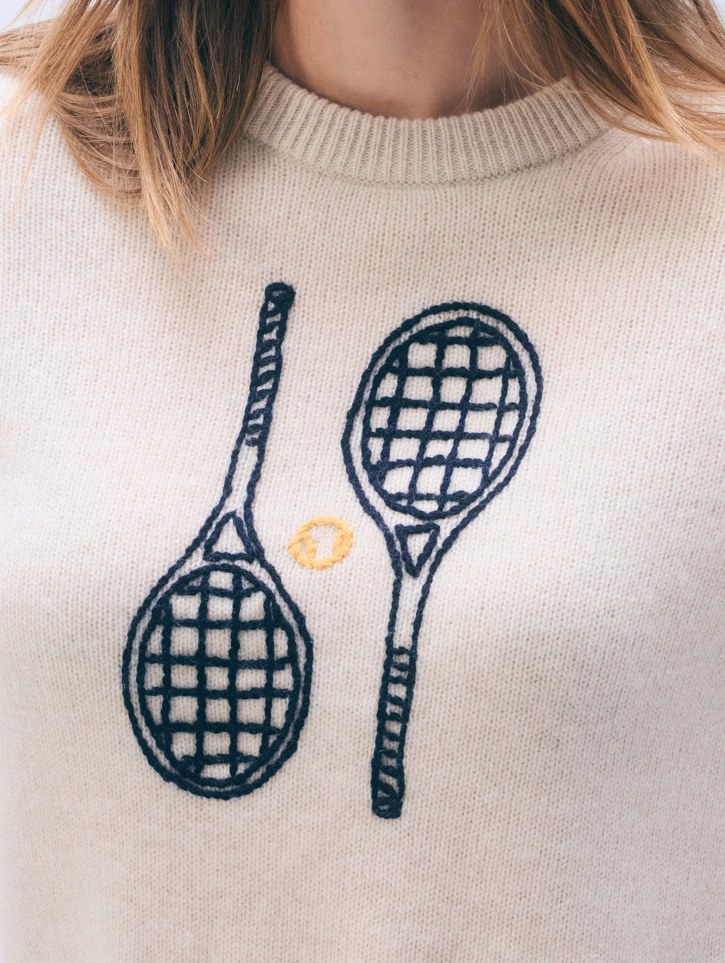 off white cashmere crewneck with embroidered tennis racquets on the front