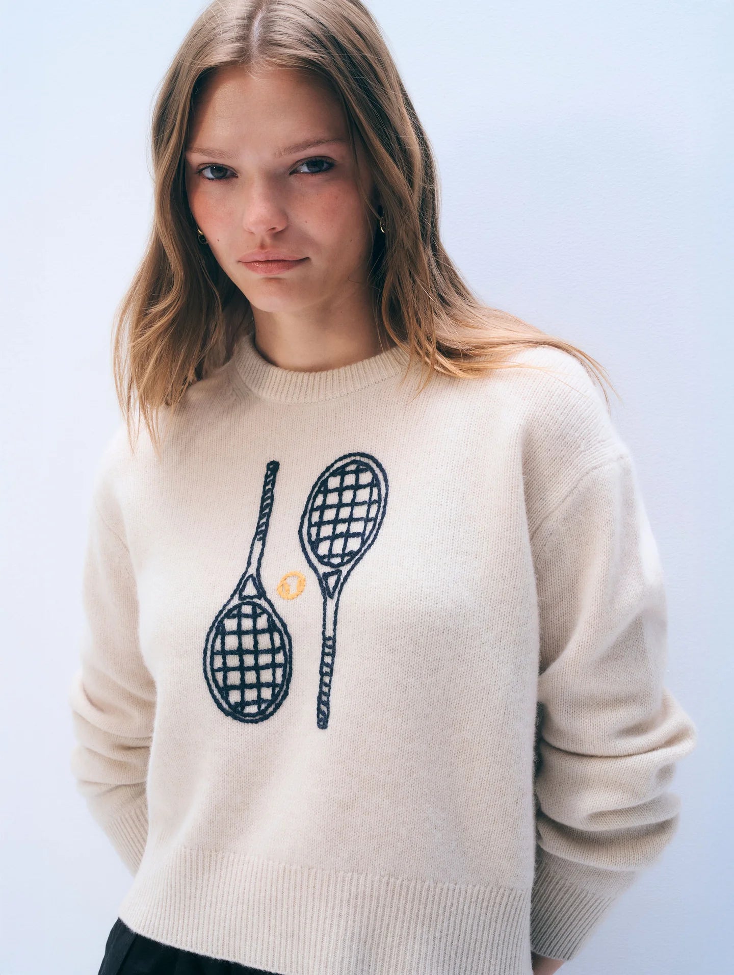 off white cashmere crewneck with embroidered tennis racquets on the front