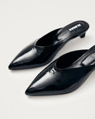 black leather mules with a pointed toe with 'Alohas' logo on them