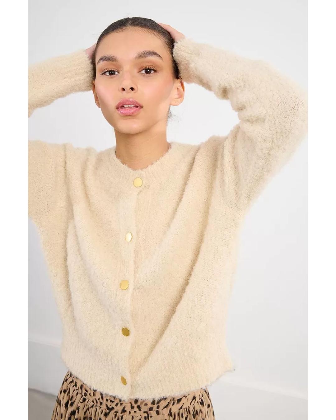 cream colored cardigan with gold buttons