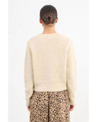 cream colored cardigan with gold buttons