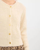 Woman wearing a beige fluffy cardigan 